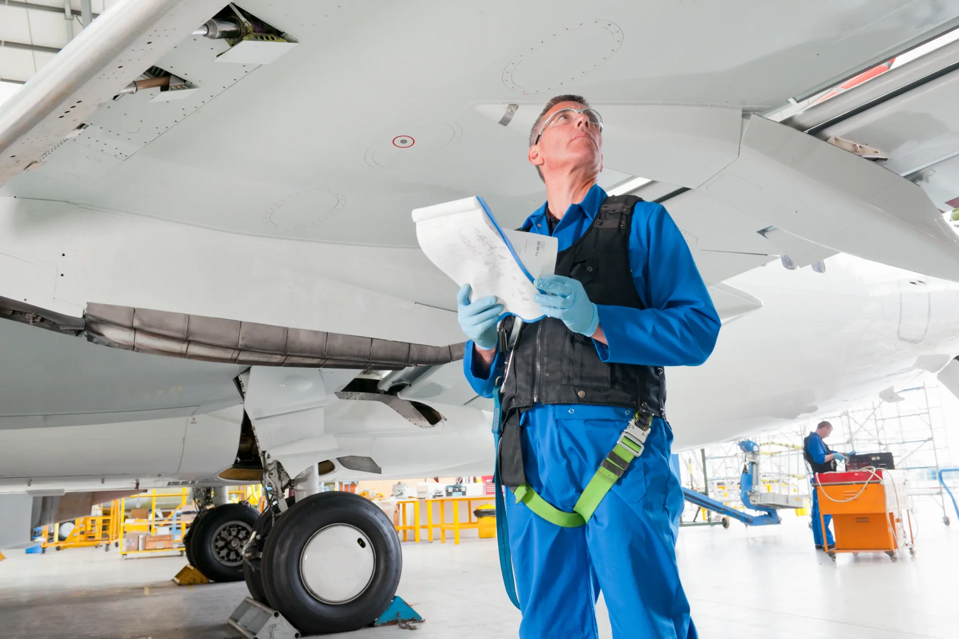 aircraft-maintenance-man-inspecting-plane-in-hangar